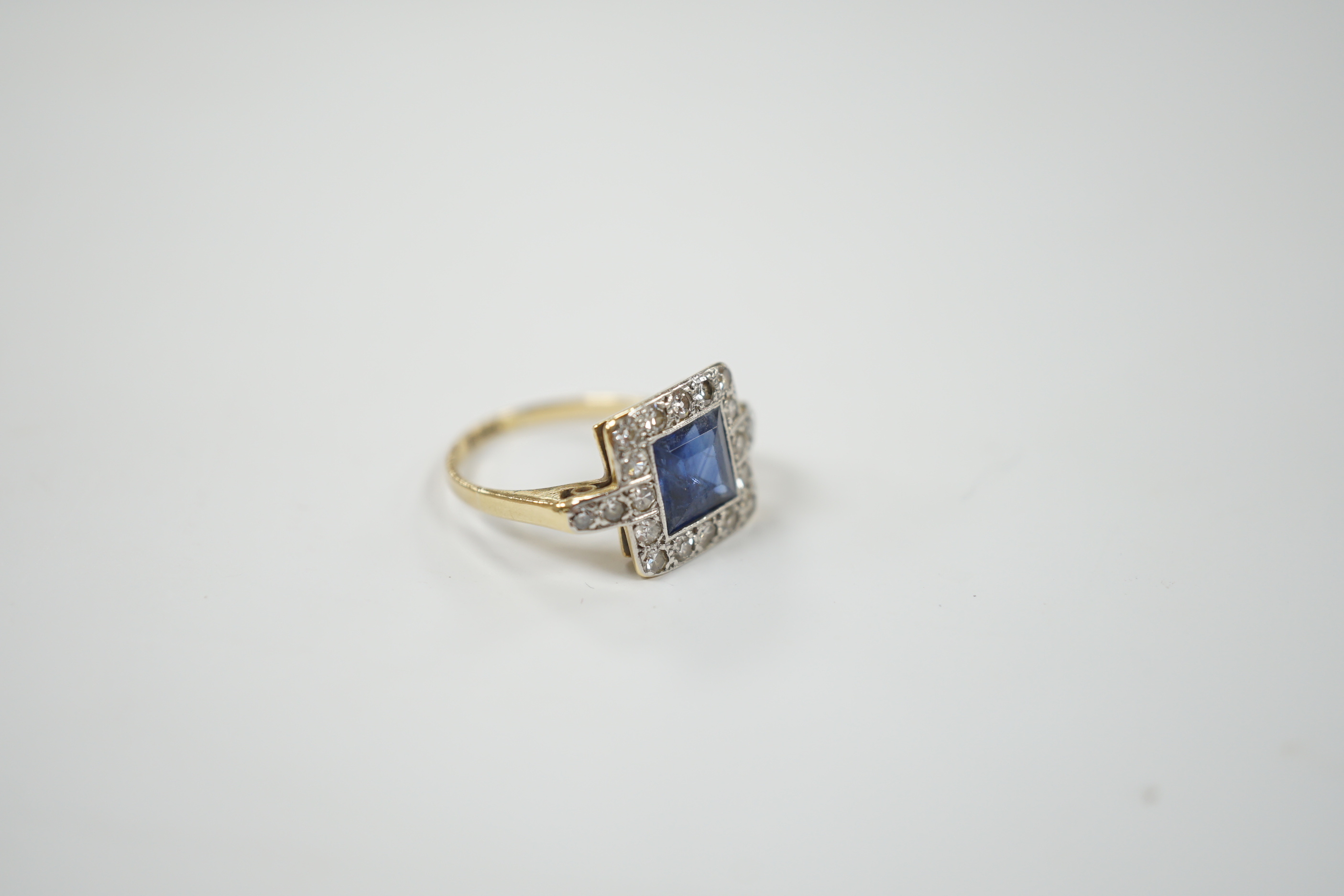 A 1940's/1950's 18ct gold & platinum, sapphire and diamond cluster set tablet ring, with diamond set shoulders, size G, gross weight 2.6 grams.